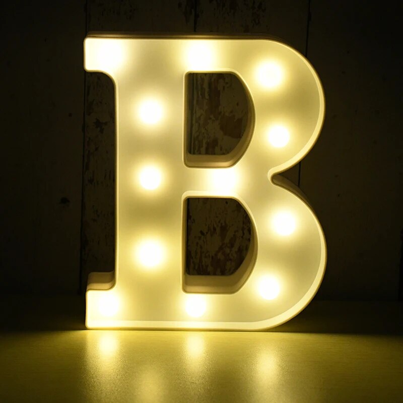 Capital letter B nightlamp illuminated by yellow LED's on a black background