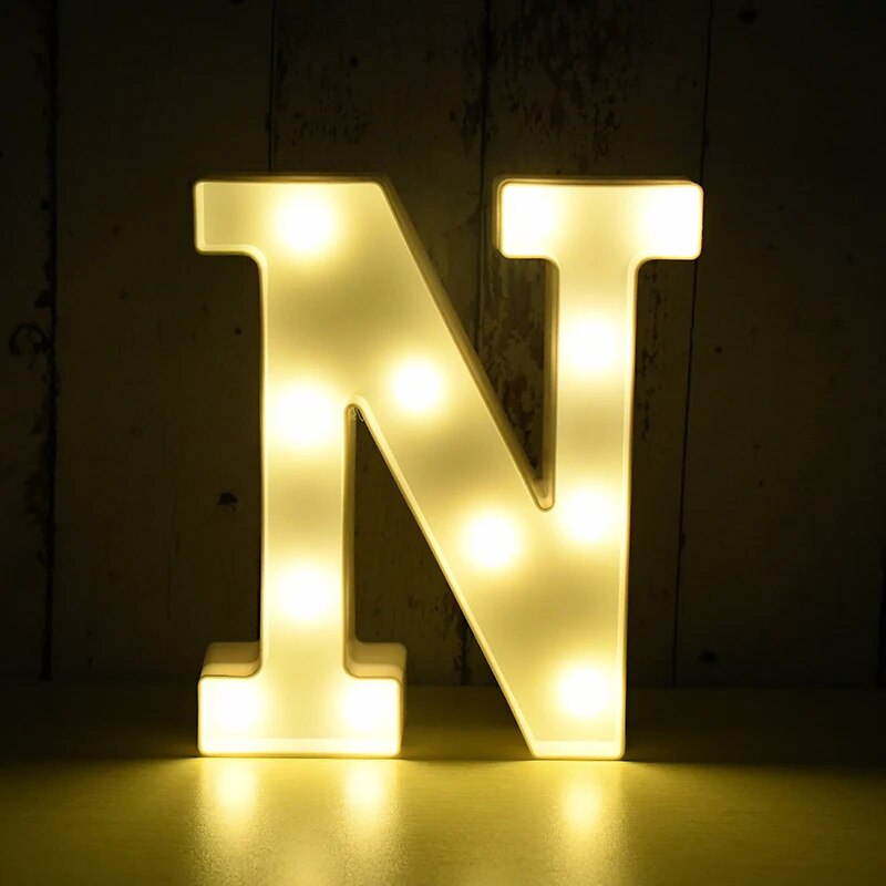 Capital letter N nightlamp illuminated by yellow LED's on a black background