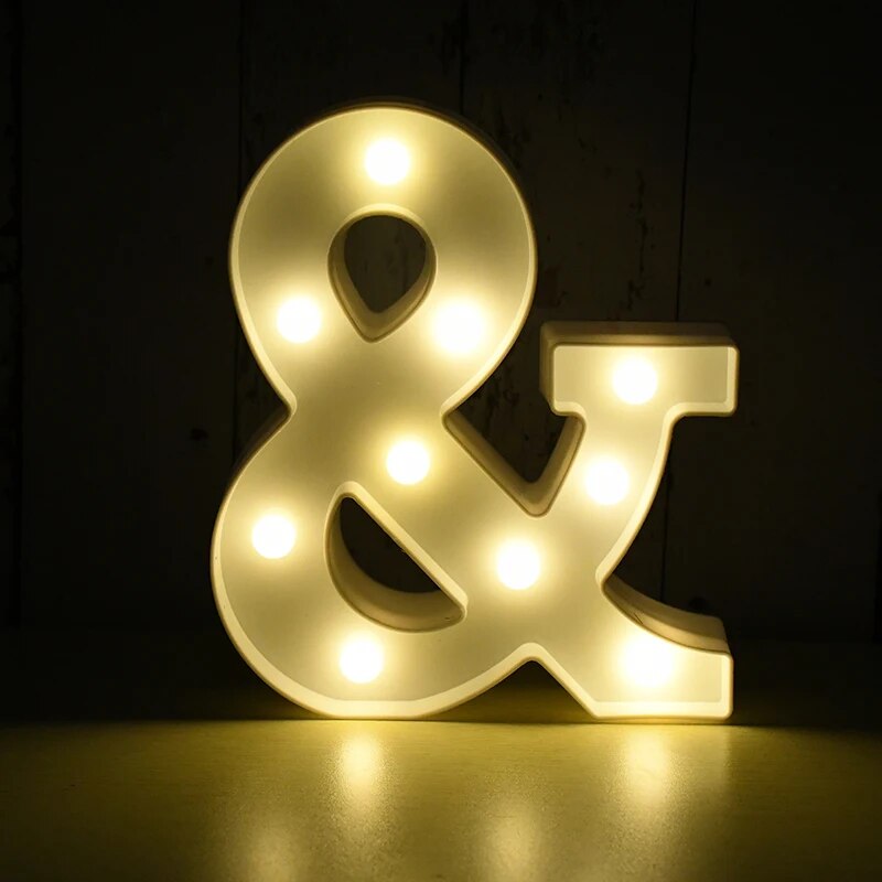 "And" symbol nightlamp illuminated by yellow LED's on a black background