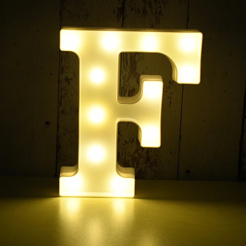 Capital letter F nightlamp illuminated by yellow LED's on a black background