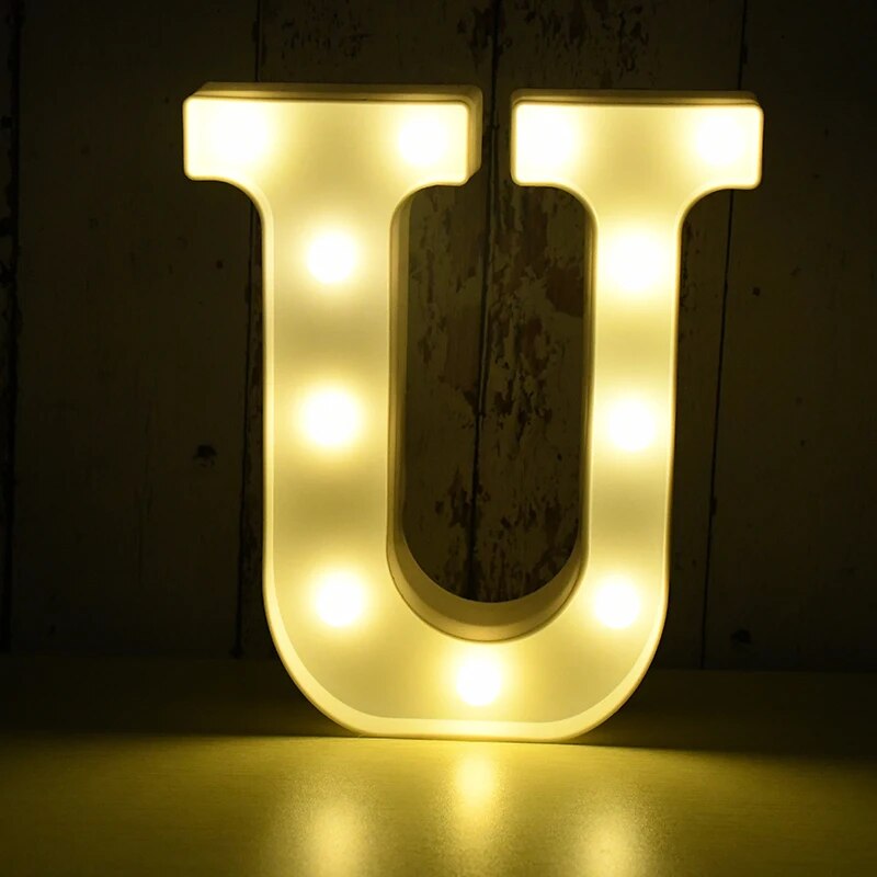 Capital letter U nightlamp illuminated by yellow LED's on a black background