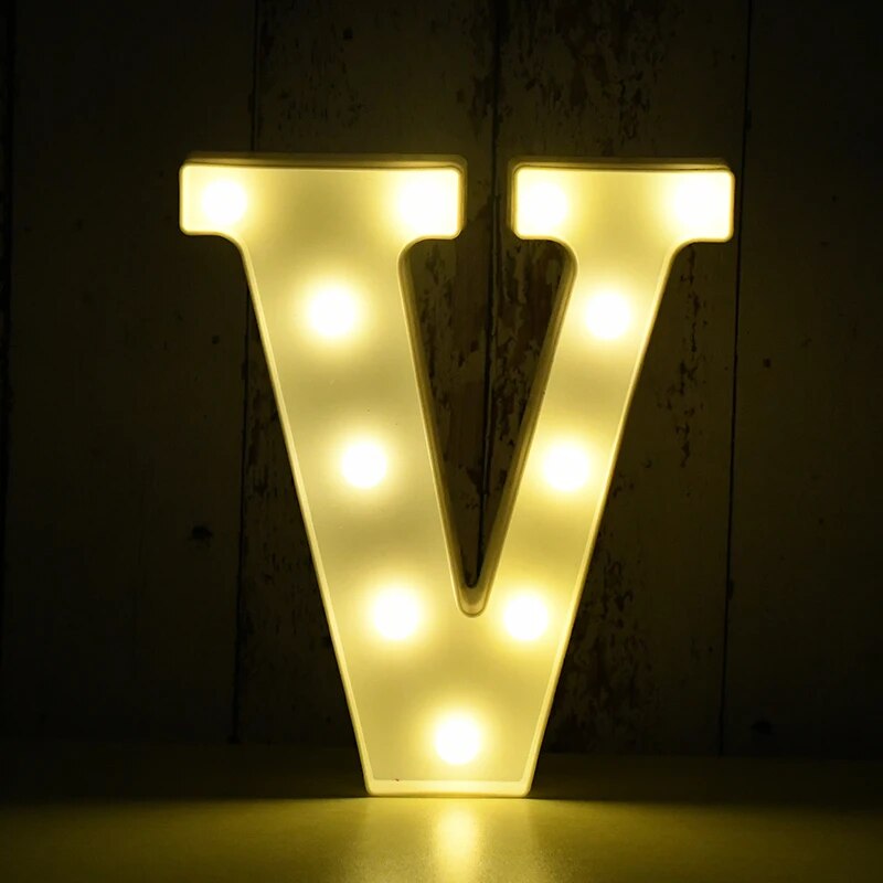 Capital letter V nightlamp illuminated by yellow LED's on a black background