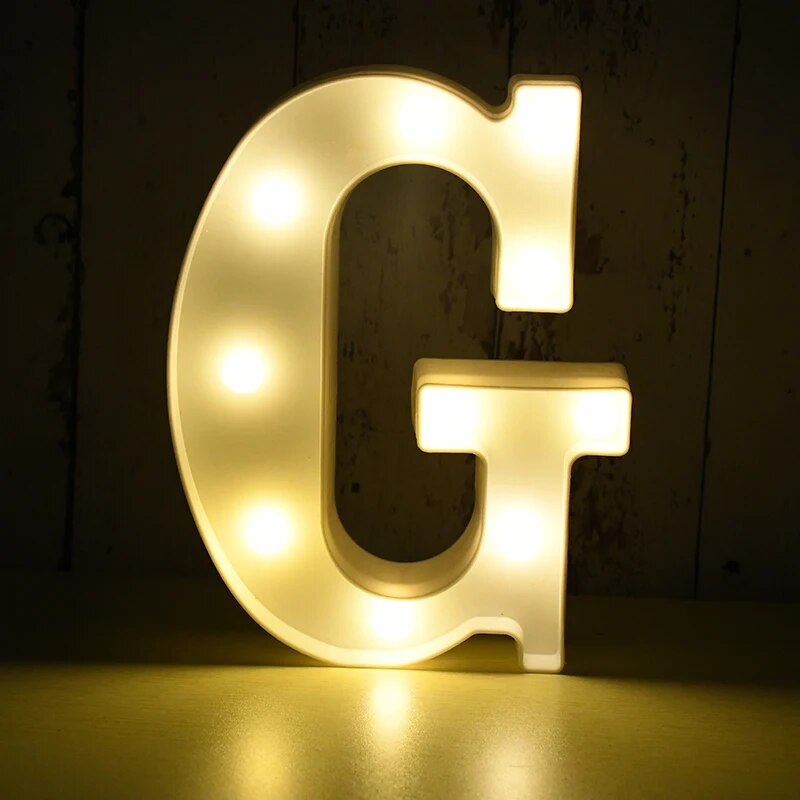 Capital letter G nightlamp illuminated by yellow LED's on a black background