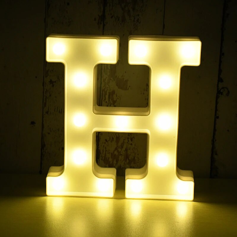 Capital letter H nightlamp illuminated by yellow LED's on a black background