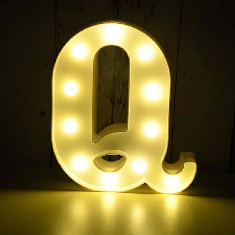 Capital letter Q nightlamp illuminated by yellow LED's on a black background