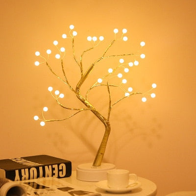 108 warm white LED mini Cristmas tree night light on table in dim lit room