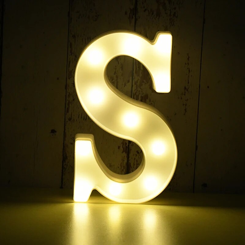 Capital letter S nightlamp illuminated by yellow LED's on a black background