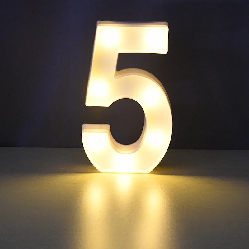 Number 5 nightlamp illuminated by yellow LED's on a black background