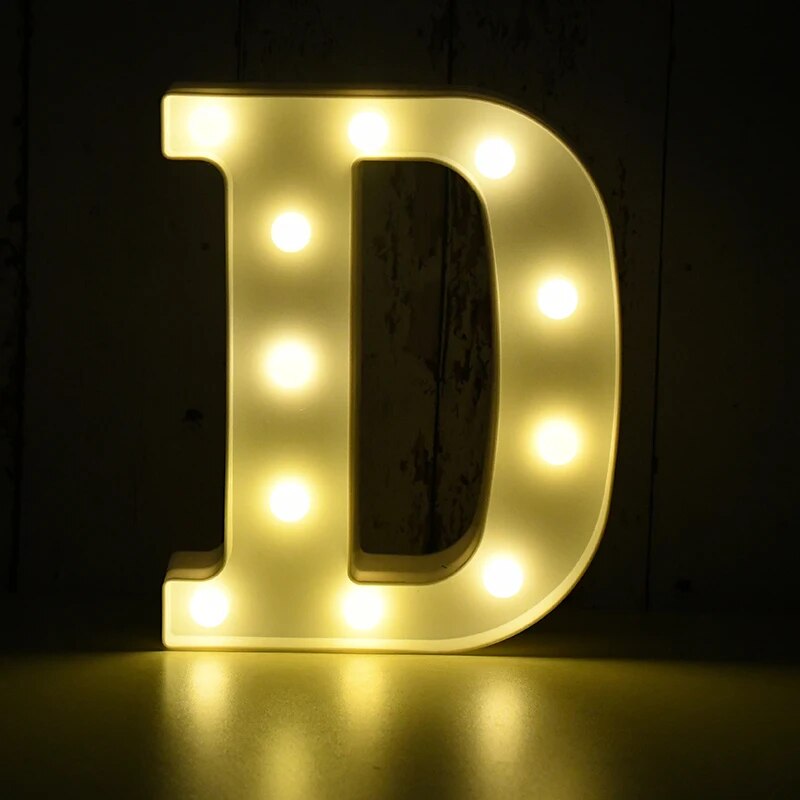 Capital letter D nightlamp illuminated by yellow LED's on a black background