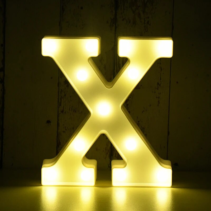 Capital letter X nightlamp illuminated by yellow LED's on a black background