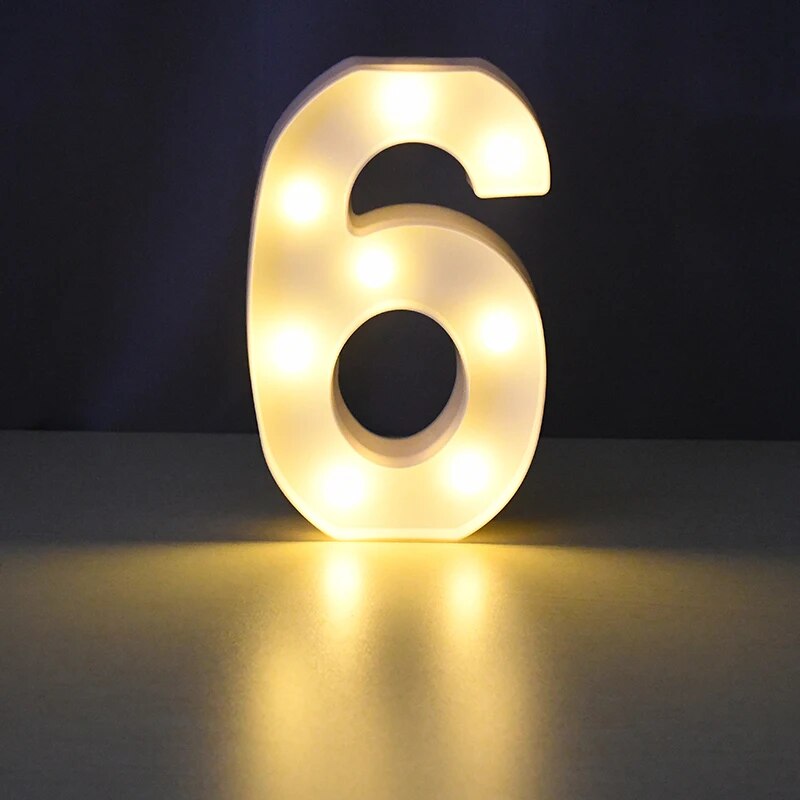 Number 6 nightlamp illuminated by yellow LED's on a black background