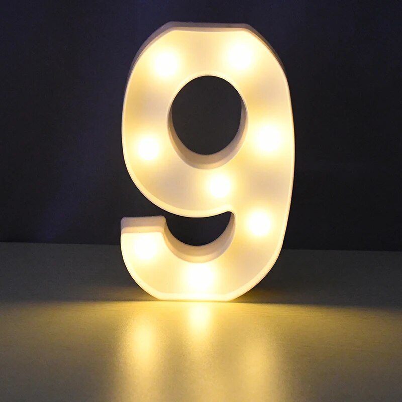 Number 9 nightlamp illuminated by yellow LED's on a black background