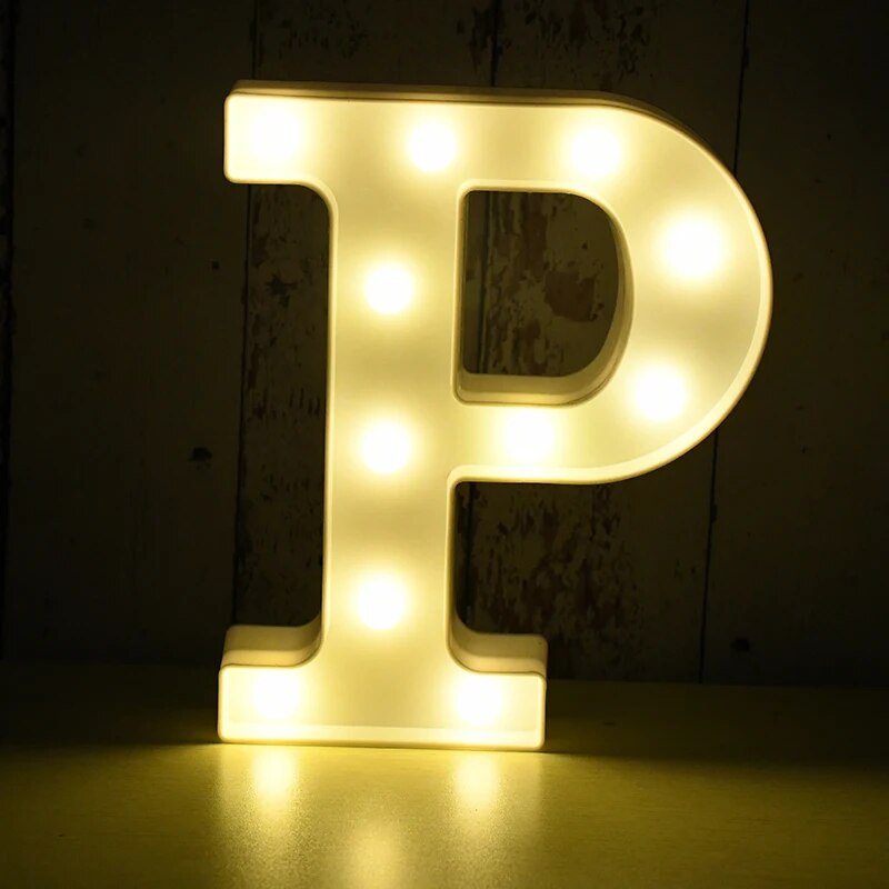 Capital letter P nightlamp illuminated by yellow LED's on a black background