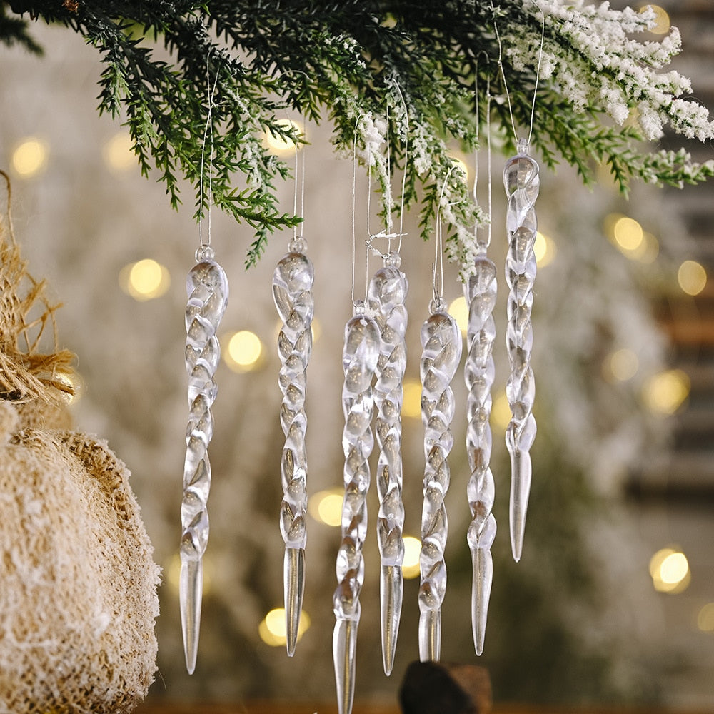 Close up of seven opaque icicle ornaments with 15 yellow Christmas tree lights on green Christmas tree.