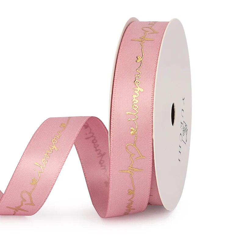 Pink ribbon that reads I love you on a white background