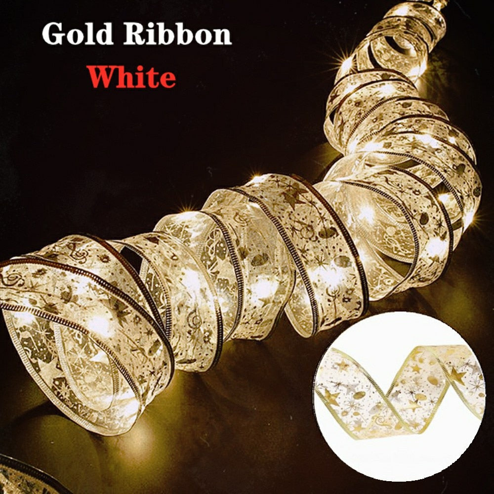 Coil of warm white illuminated gold ribbon in a dark room