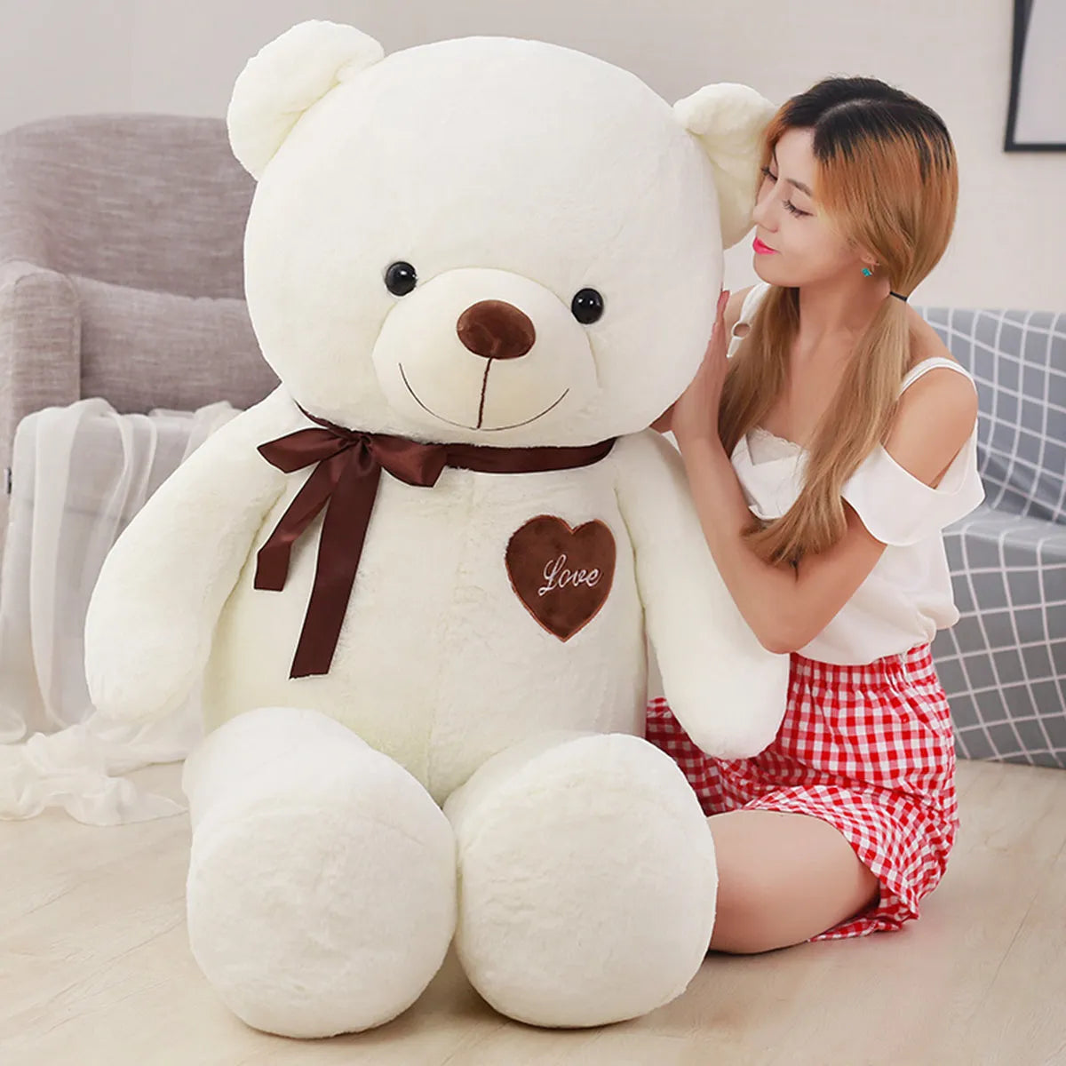  Large white teddy bear wearing brown scarf and heart