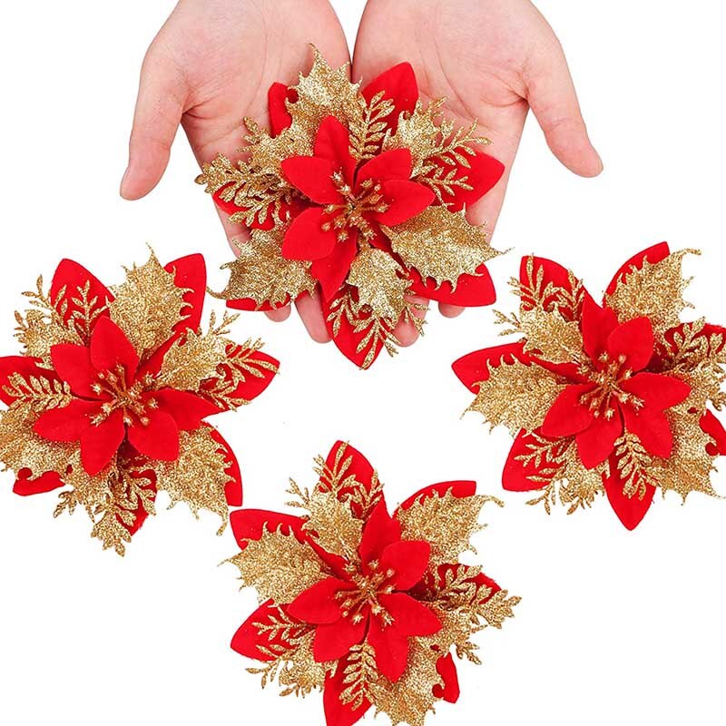 Four fourteen cm red artificial Christmas flowers with a light bronze center on a white background with one flower being held with two hands.