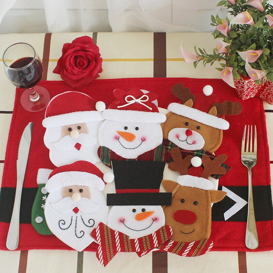 2 santa, 2 snowmen, 1reindeer, 1 bear Christmas tableware pouch on red placemat